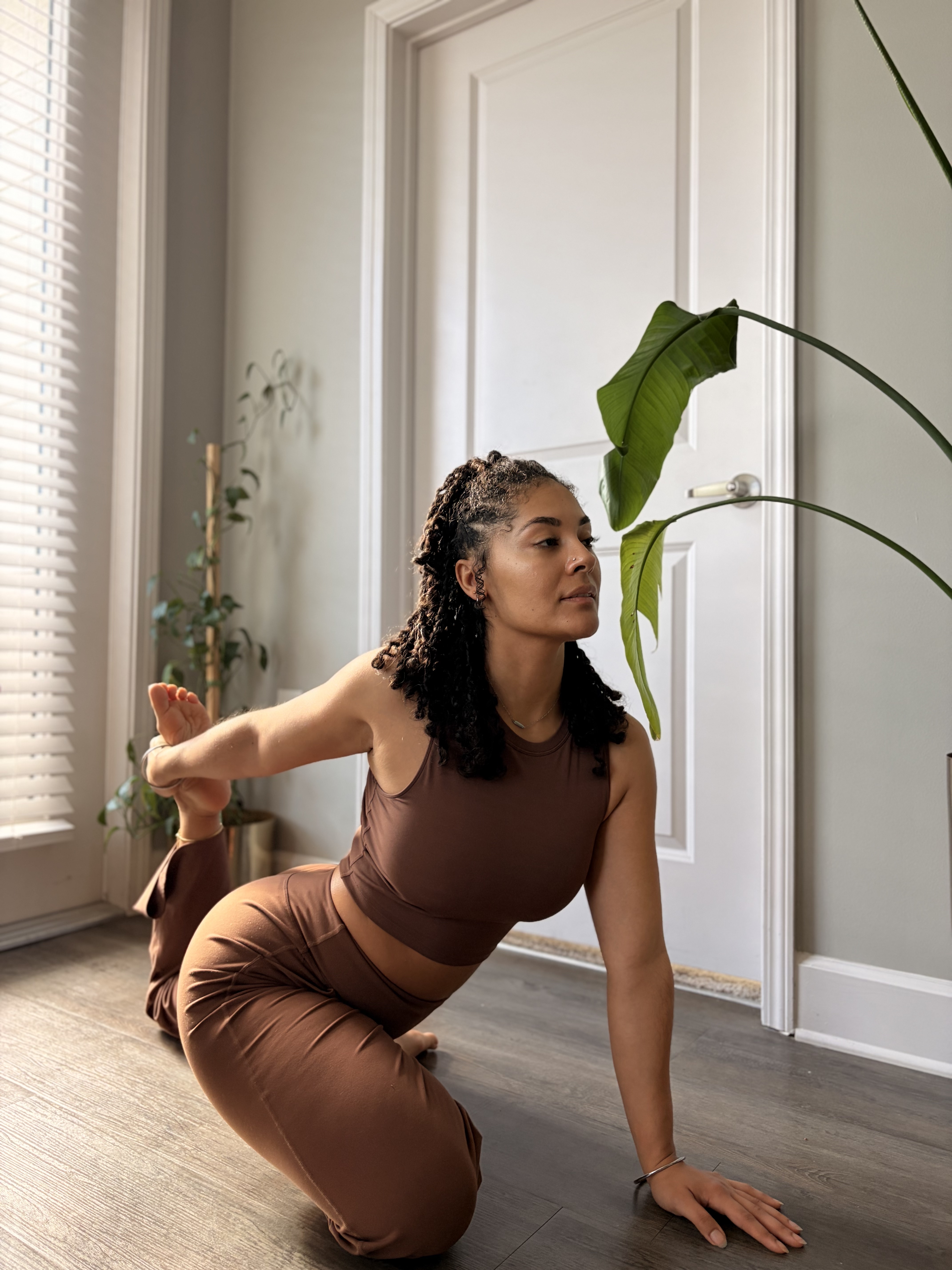 Image of yoga instructor in a half pigeon pose